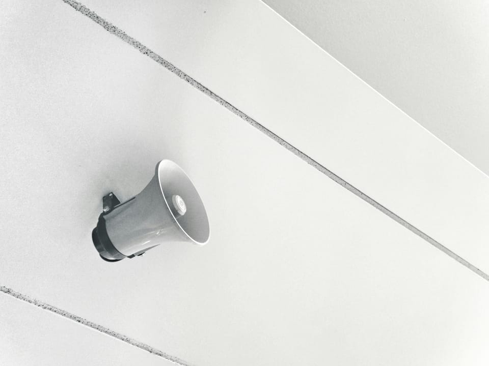 Grey megaphone on wall.